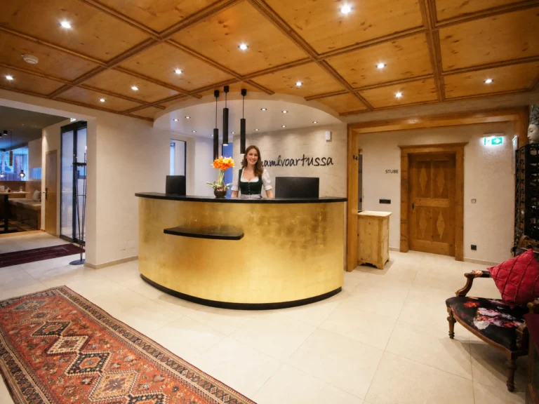 Receptionist in Dirndl at Hotel Die Arlbergerin reception St. Anton am Arlberg